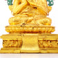 A solemn gilt bronze statue of the Guru