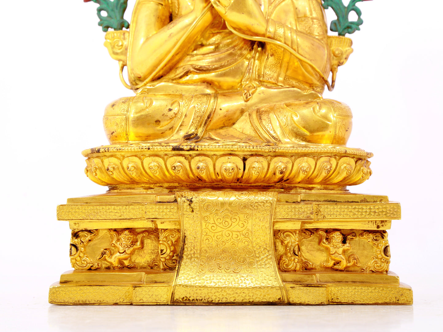 A solemn gilt bronze statue of the Guru