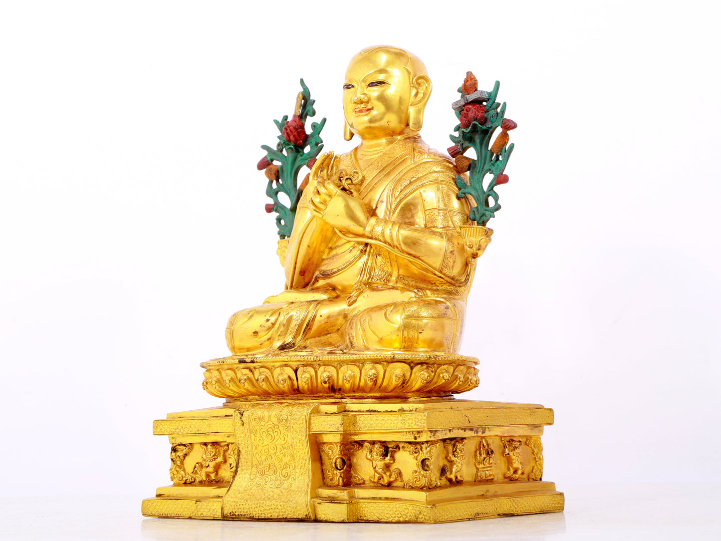 A solemn gilt bronze statue of the Guru