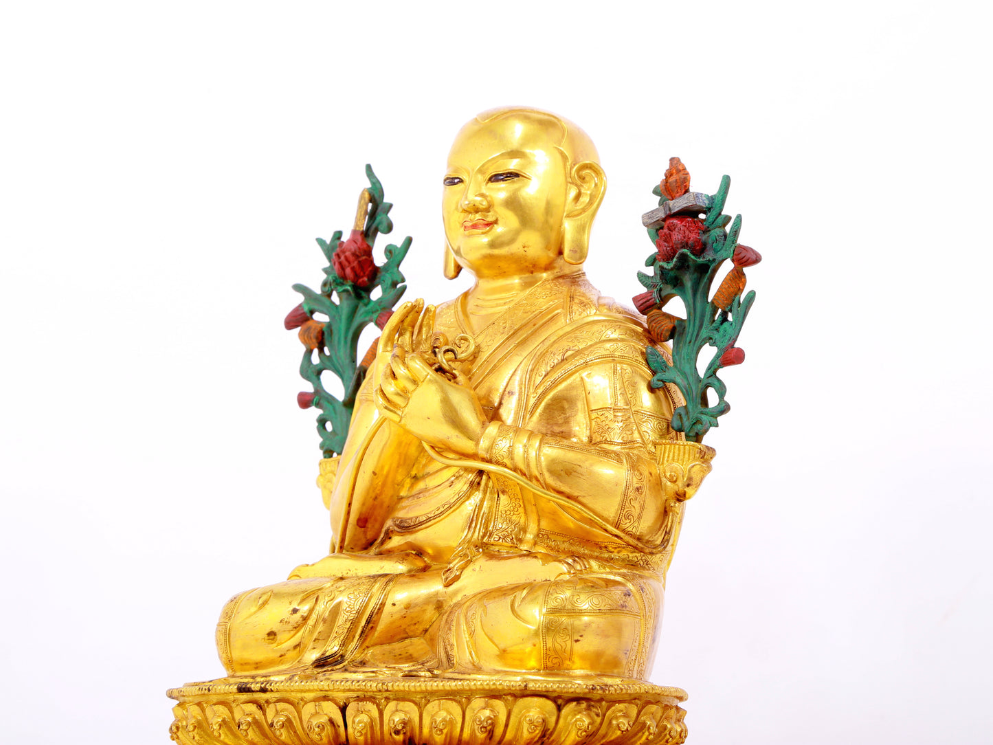 A solemn gilt bronze statue of the Guru