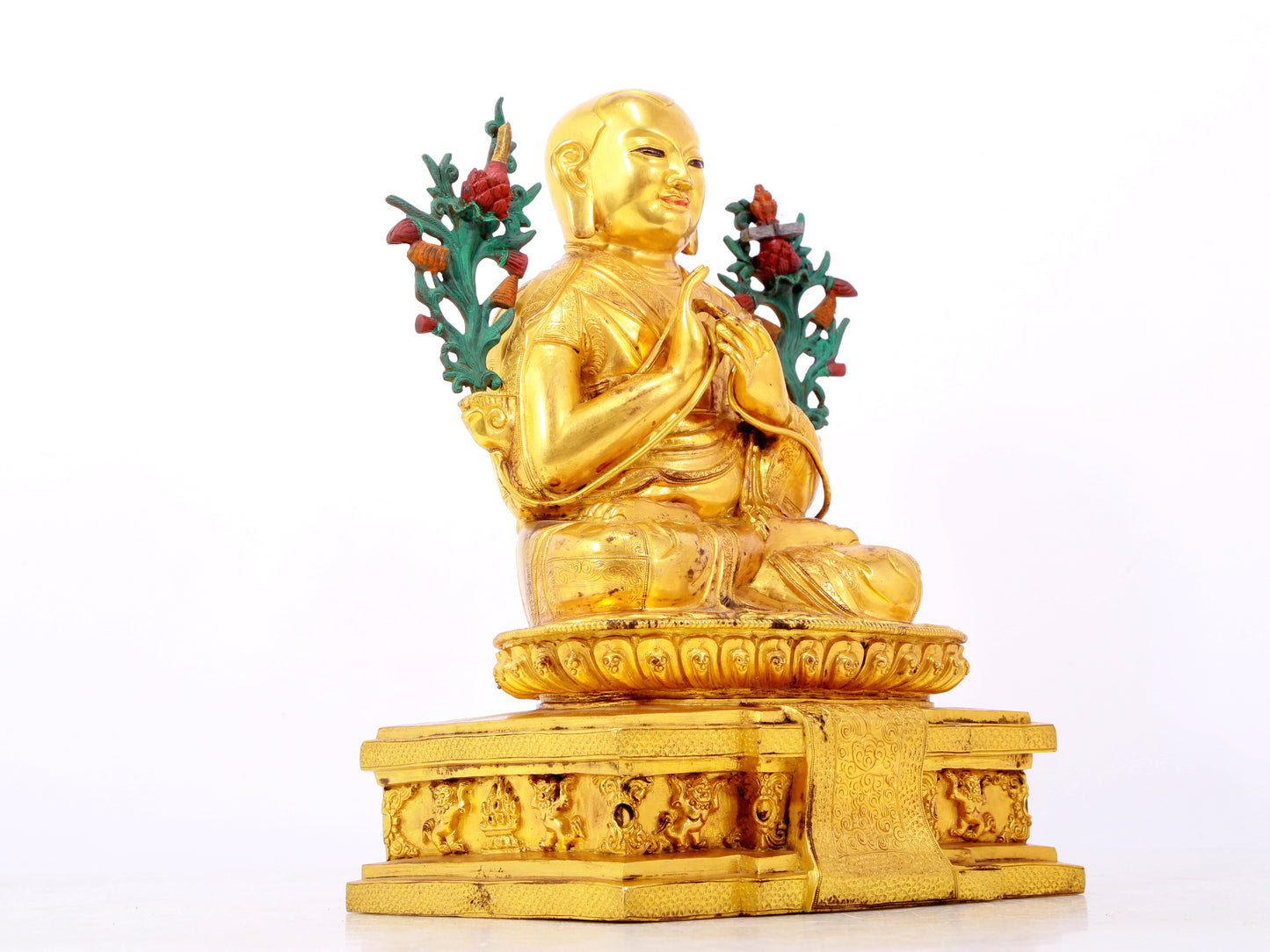 A solemn gilt bronze statue of the Guru