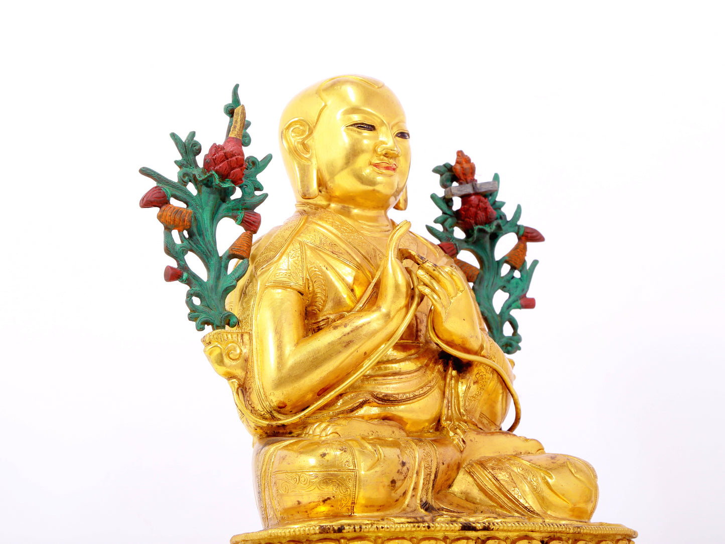 A solemn gilt bronze statue of the Guru