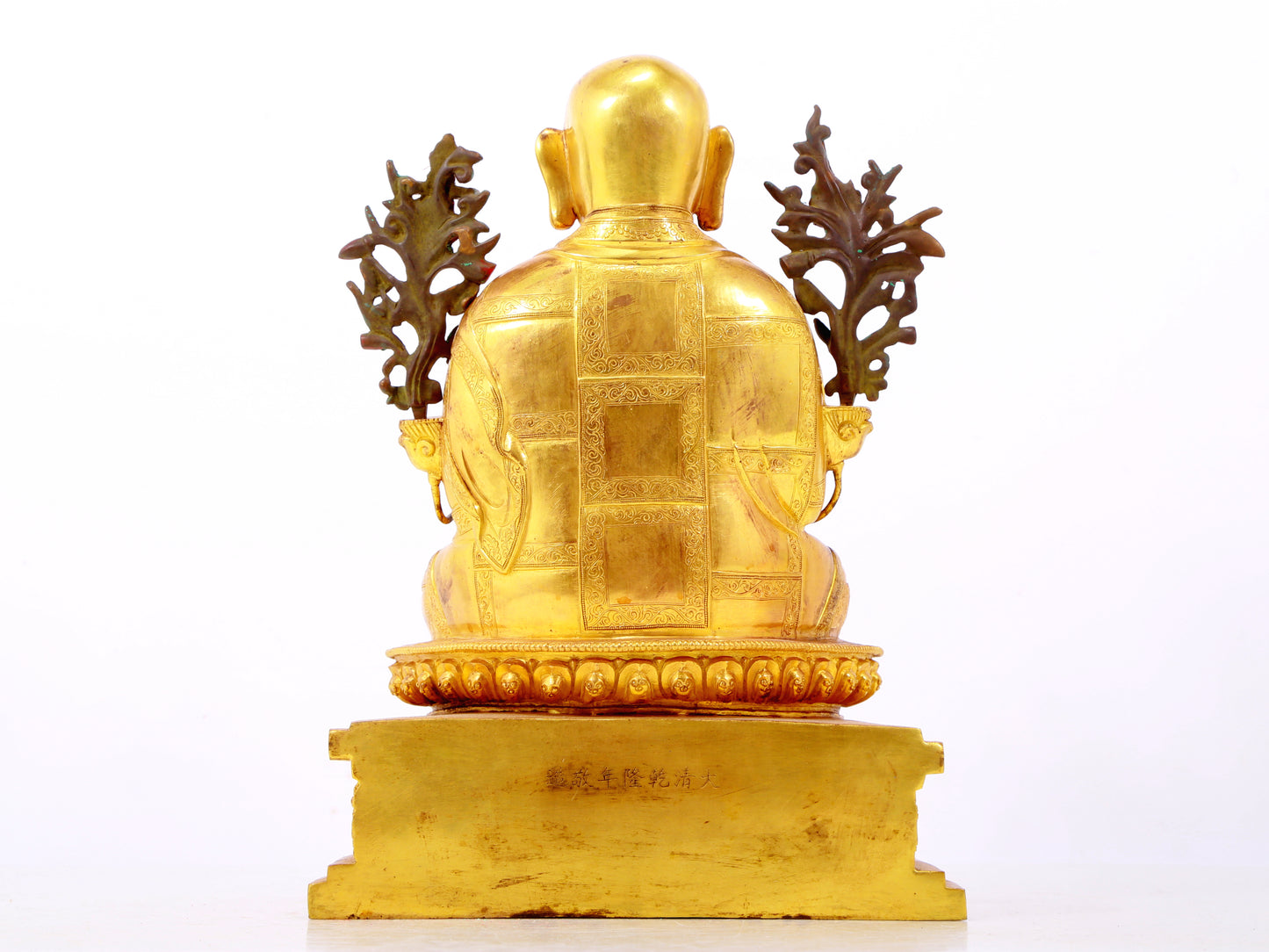 A solemn gilt bronze statue of the Guru