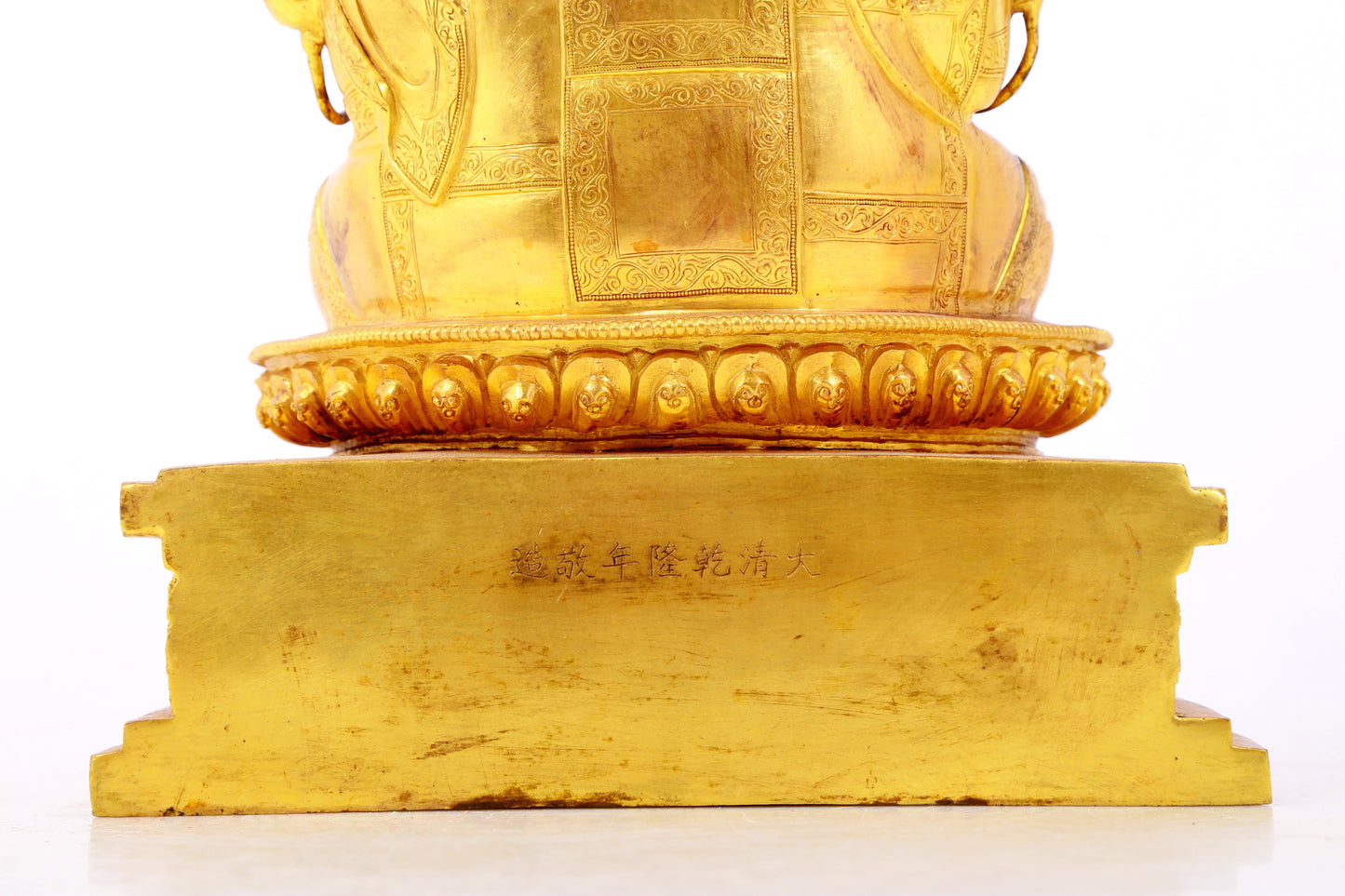 A solemn gilt bronze statue of the Guru