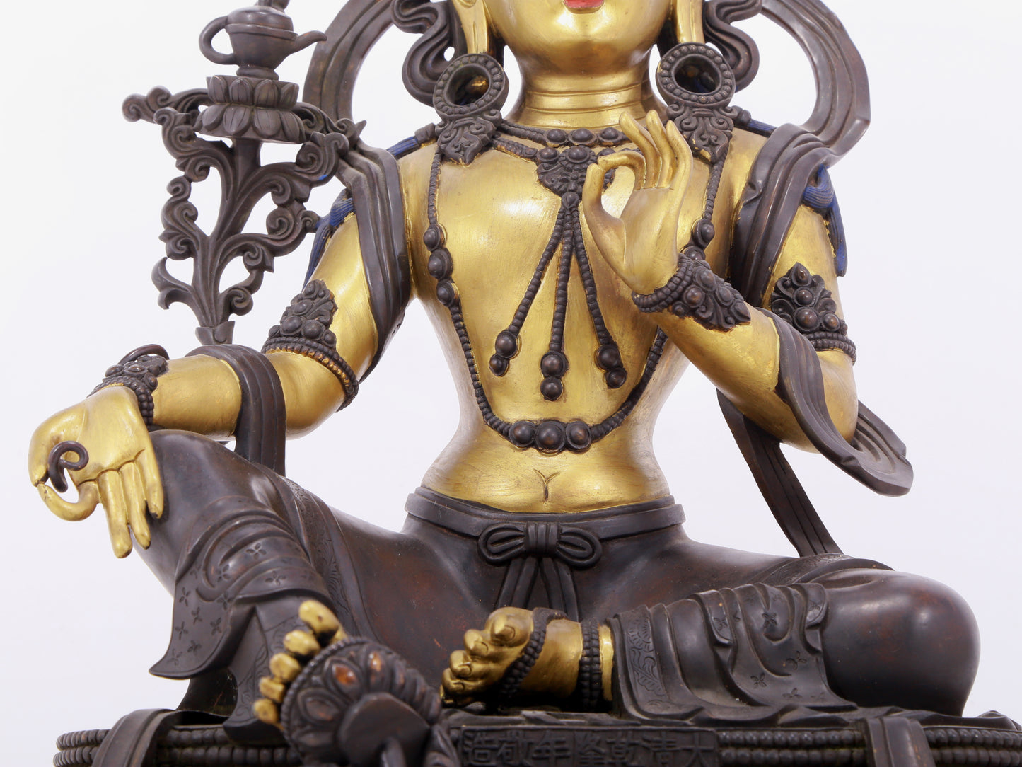 A solemn gilt bronze statue of green Tara