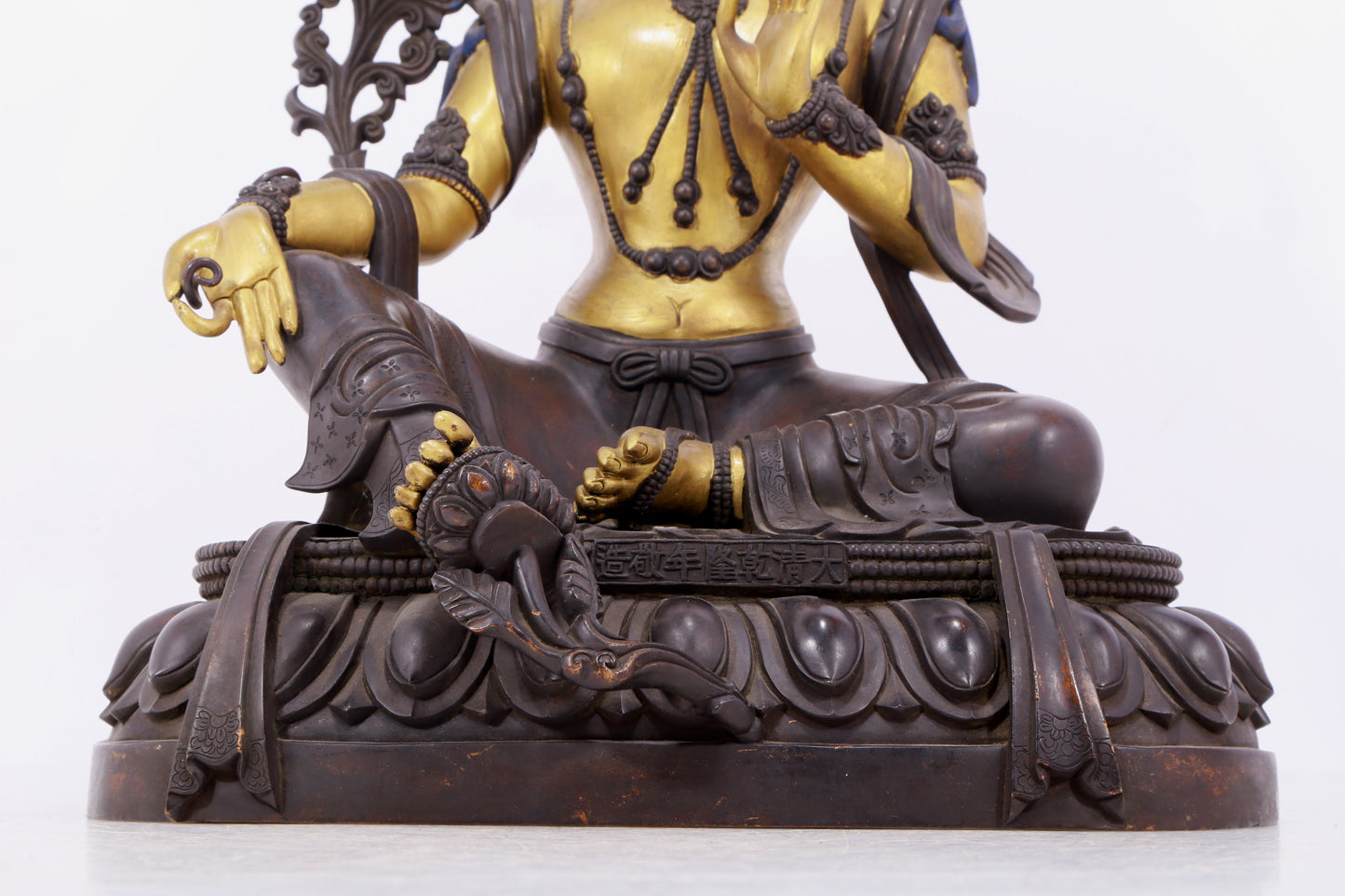 A solemn gilt bronze statue of green Tara