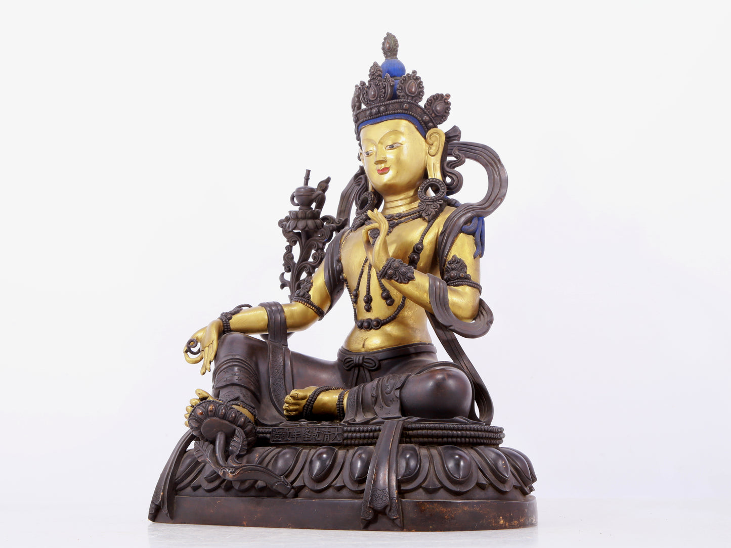 A solemn gilt bronze statue of green Tara