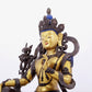 A solemn gilt bronze statue of green Tara