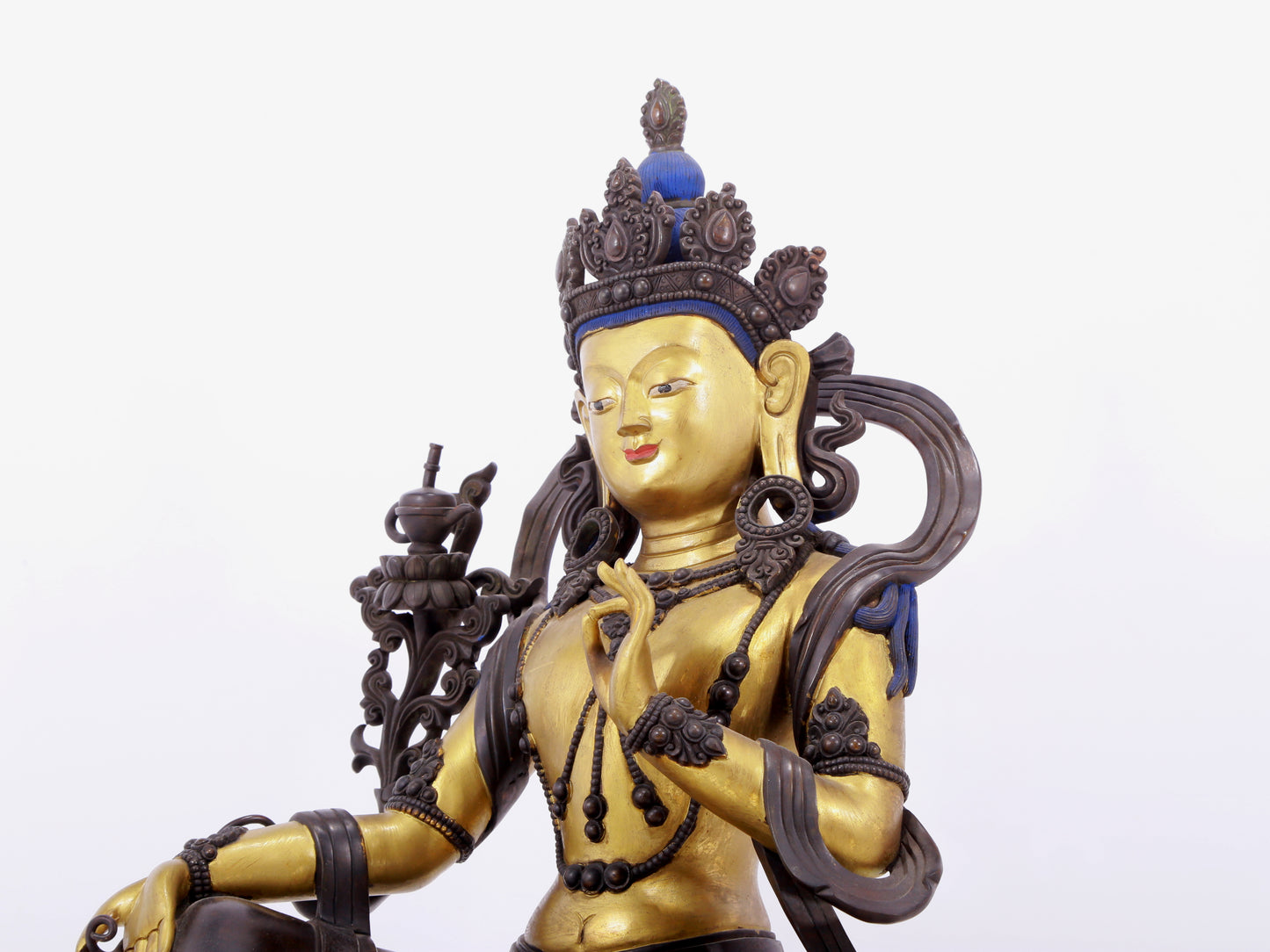 A solemn gilt bronze statue of green Tara