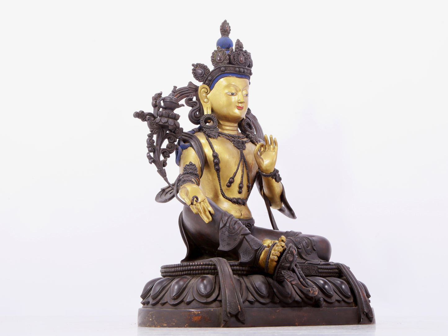 A solemn gilt bronze statue of green Tara