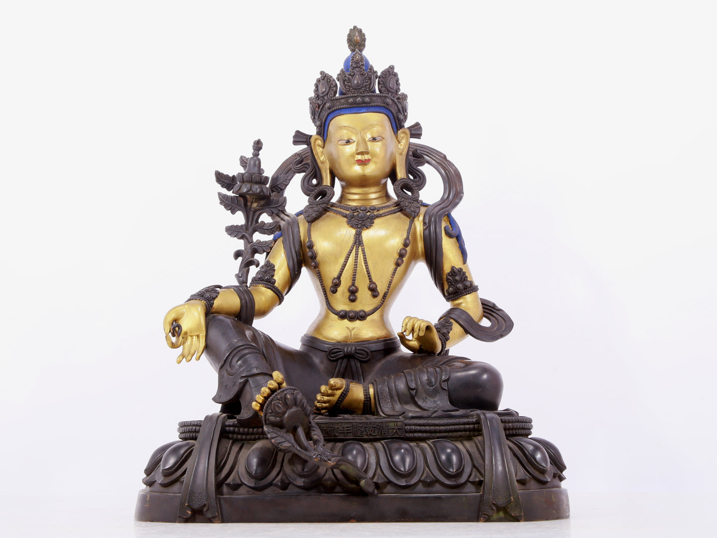 A solemn gilt bronze statue of green Tara