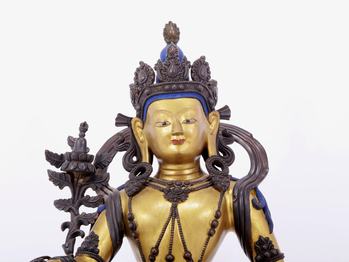 A solemn gilt bronze statue of green Tara