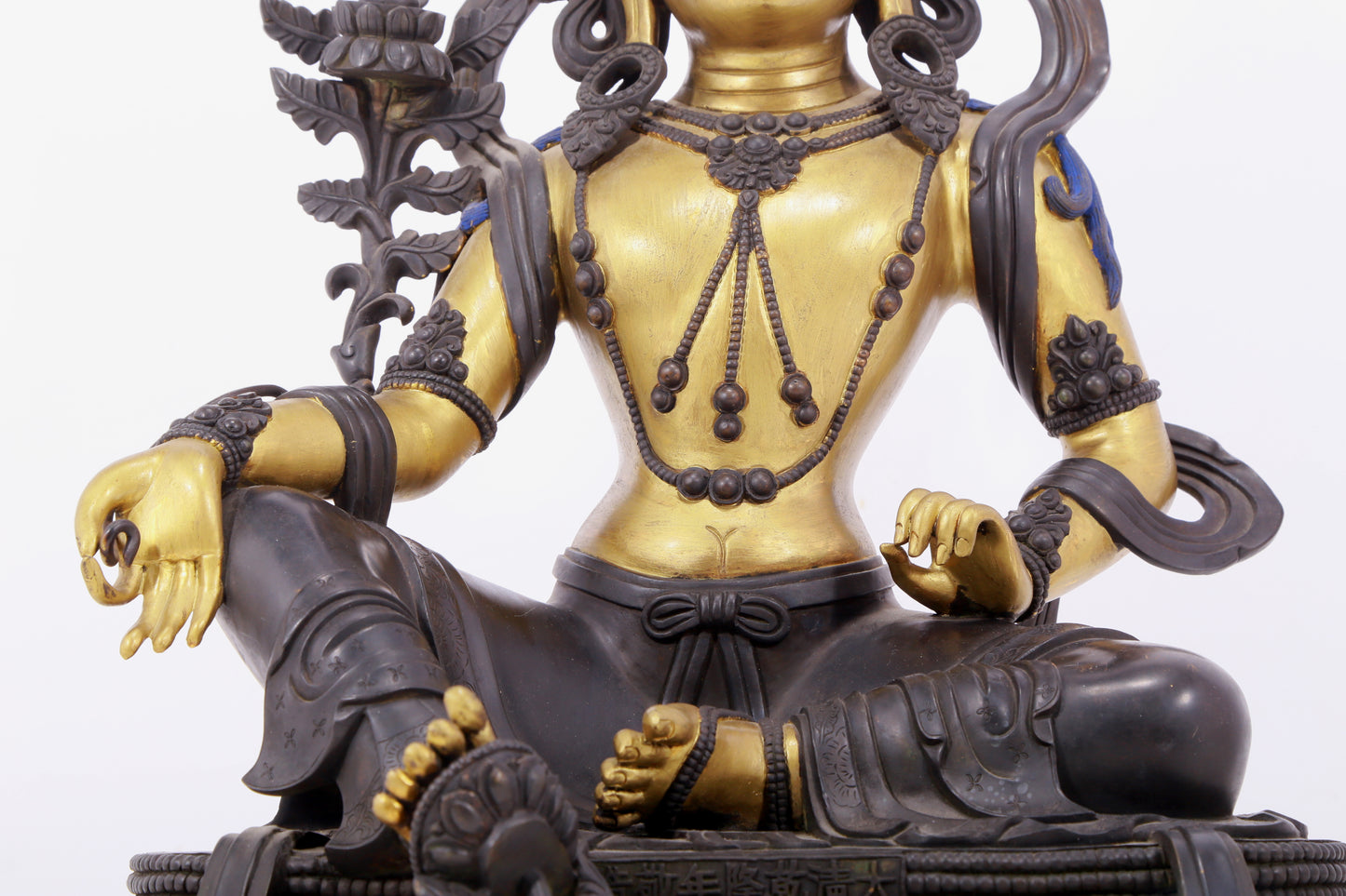 A solemn gilt bronze statue of green Tara