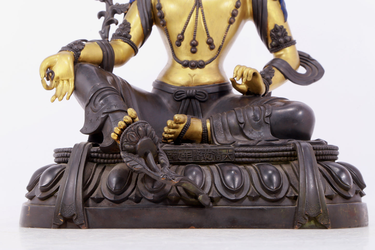 A solemn gilt bronze statue of green Tara