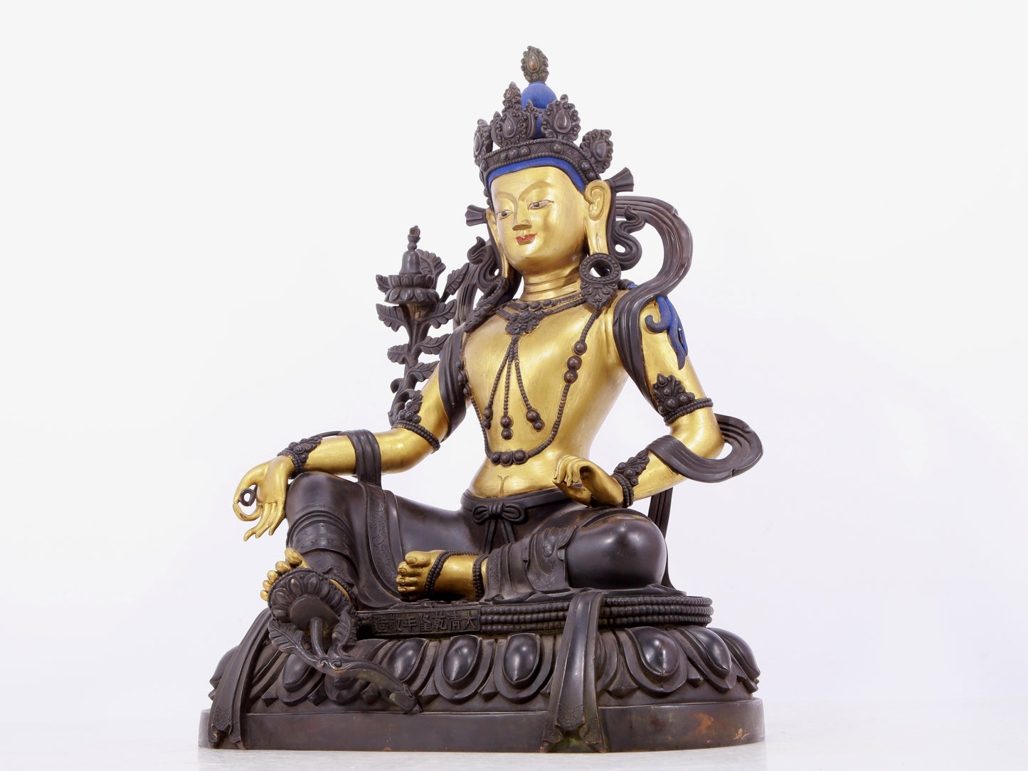 A solemn gilt bronze statue of green Tara