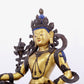 A solemn gilt bronze statue of green Tara