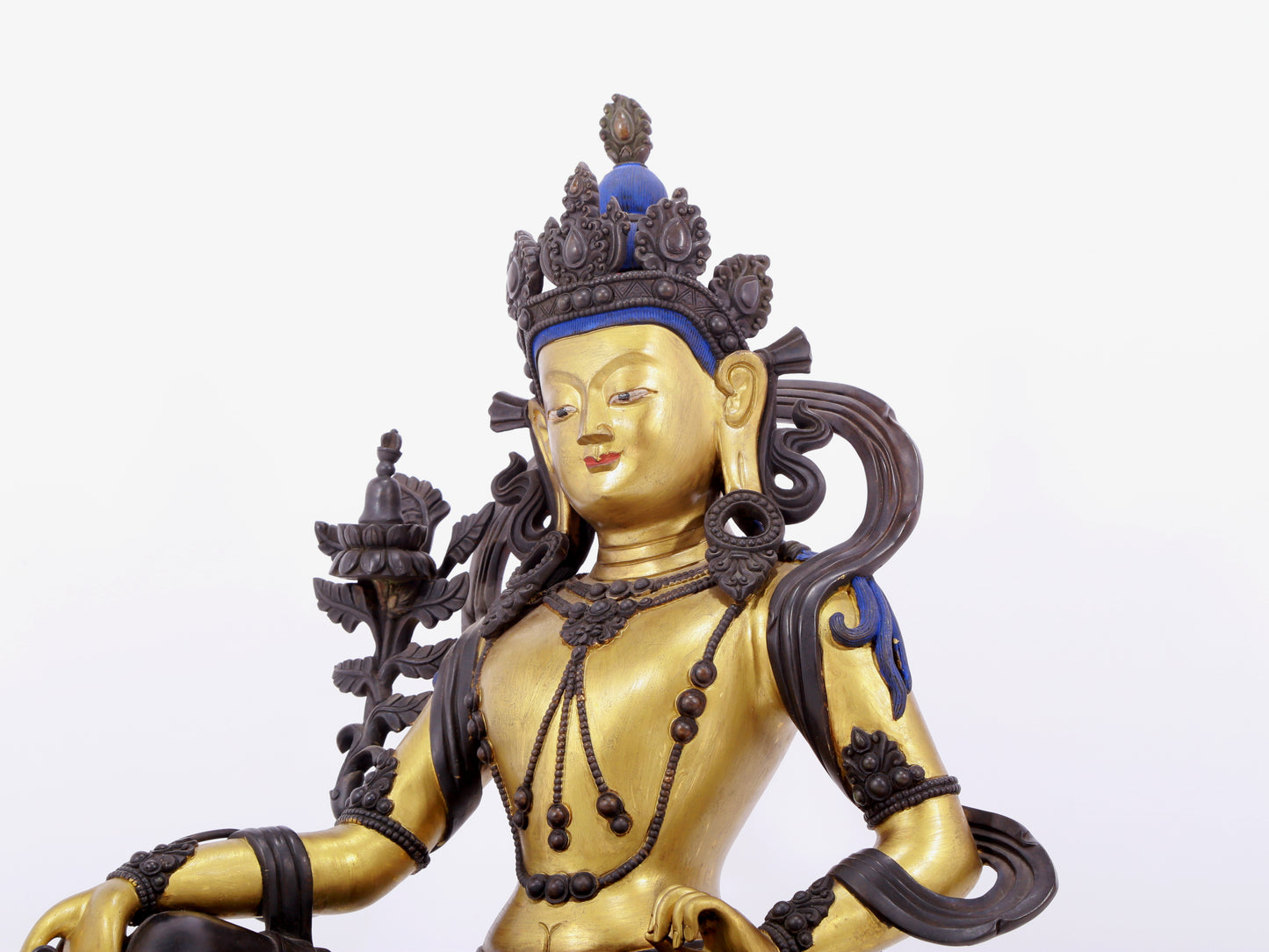 A solemn gilt bronze statue of green Tara