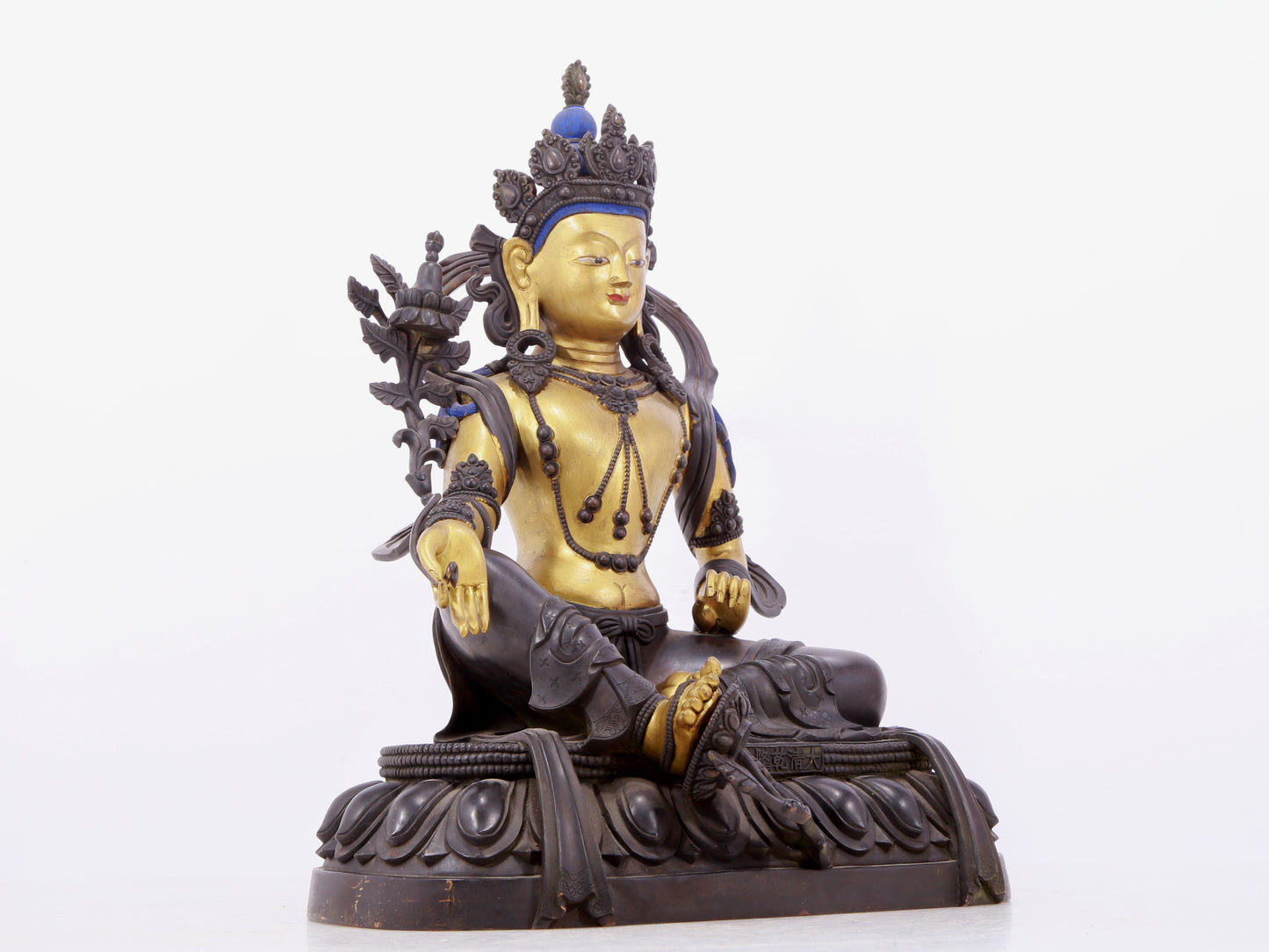 A solemn gilt bronze statue of green Tara