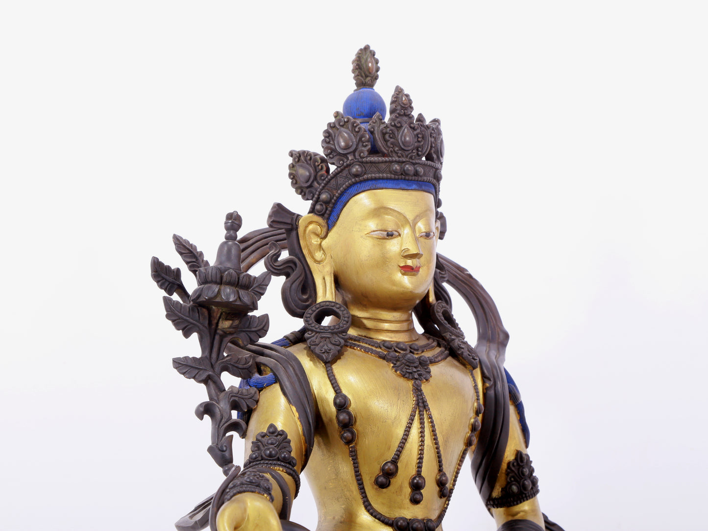 A solemn gilt bronze statue of green Tara