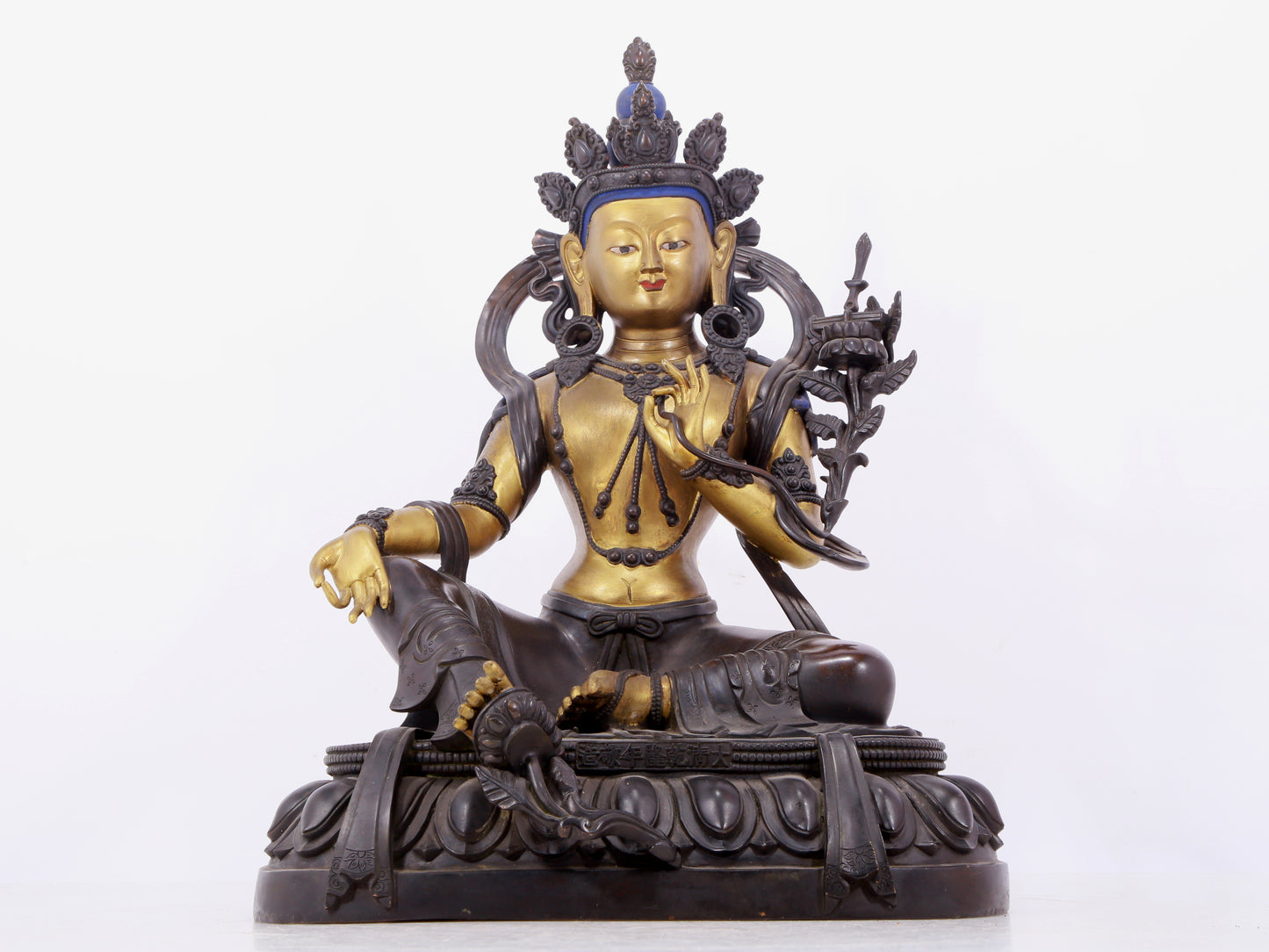 A solemn gilt bronze statue of green Tara