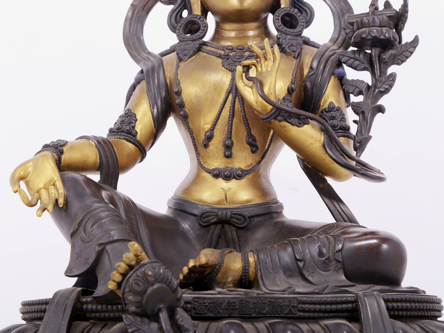 A solemn gilt bronze statue of green Tara