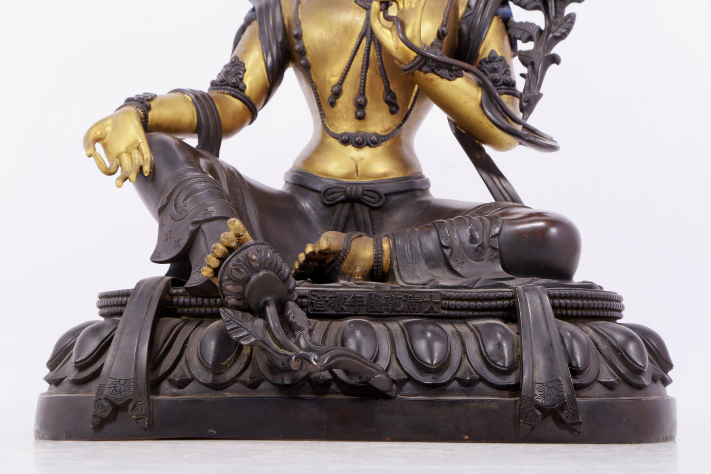 A solemn gilt bronze statue of green Tara