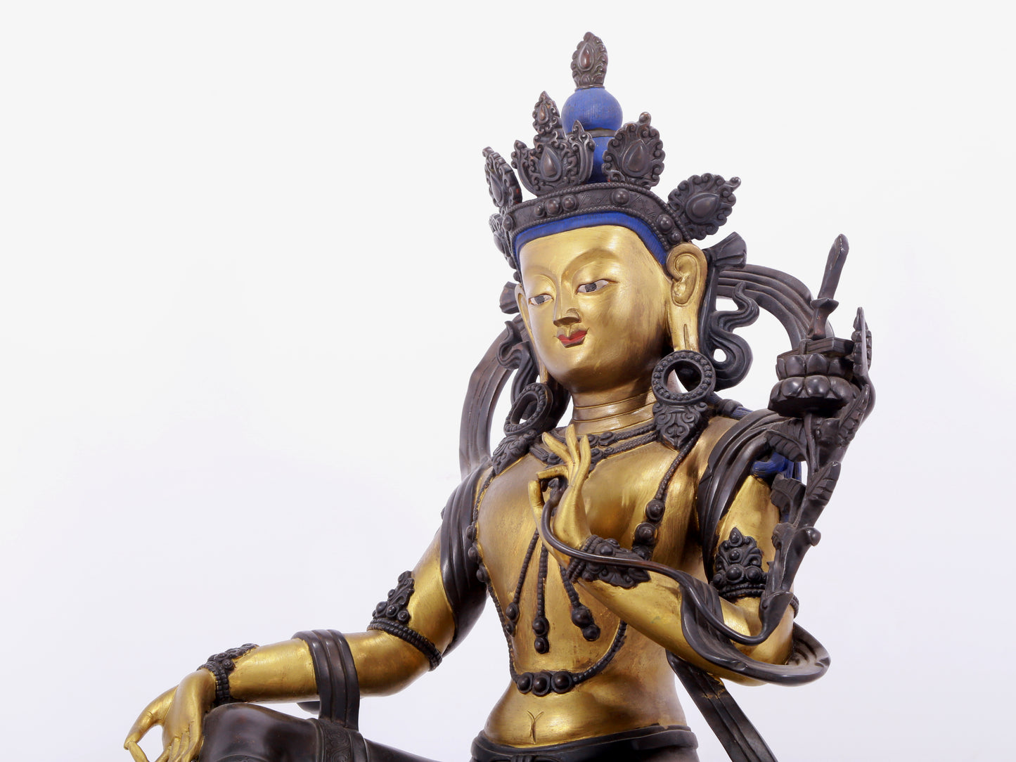 A solemn gilt bronze statue of green Tara