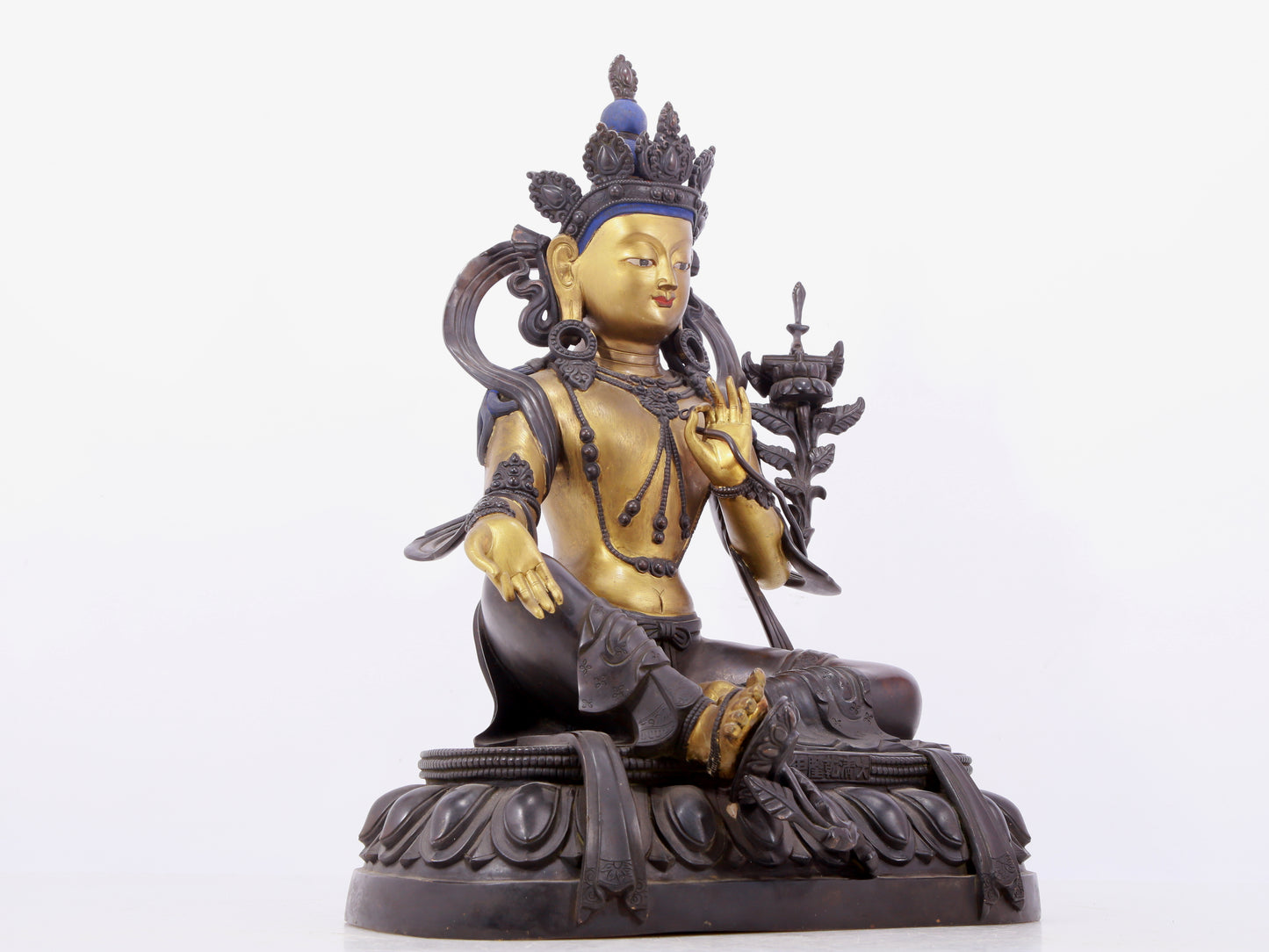 A solemn gilt bronze statue of green Tara