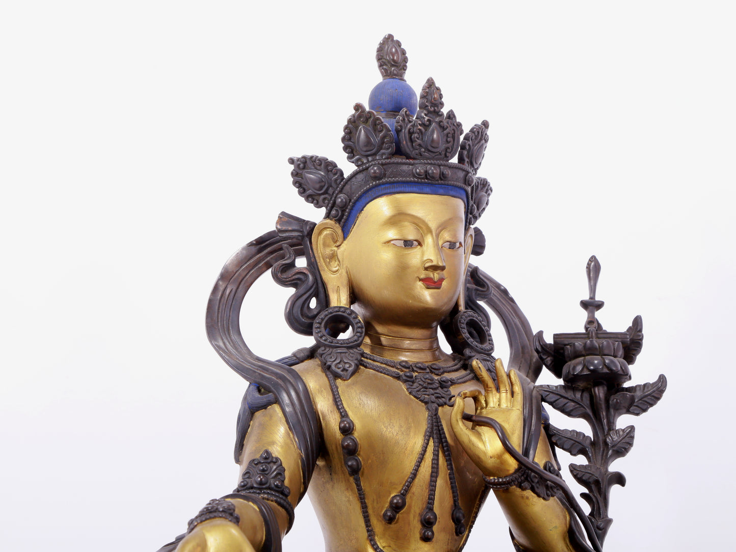 A solemn gilt bronze statue of green Tara