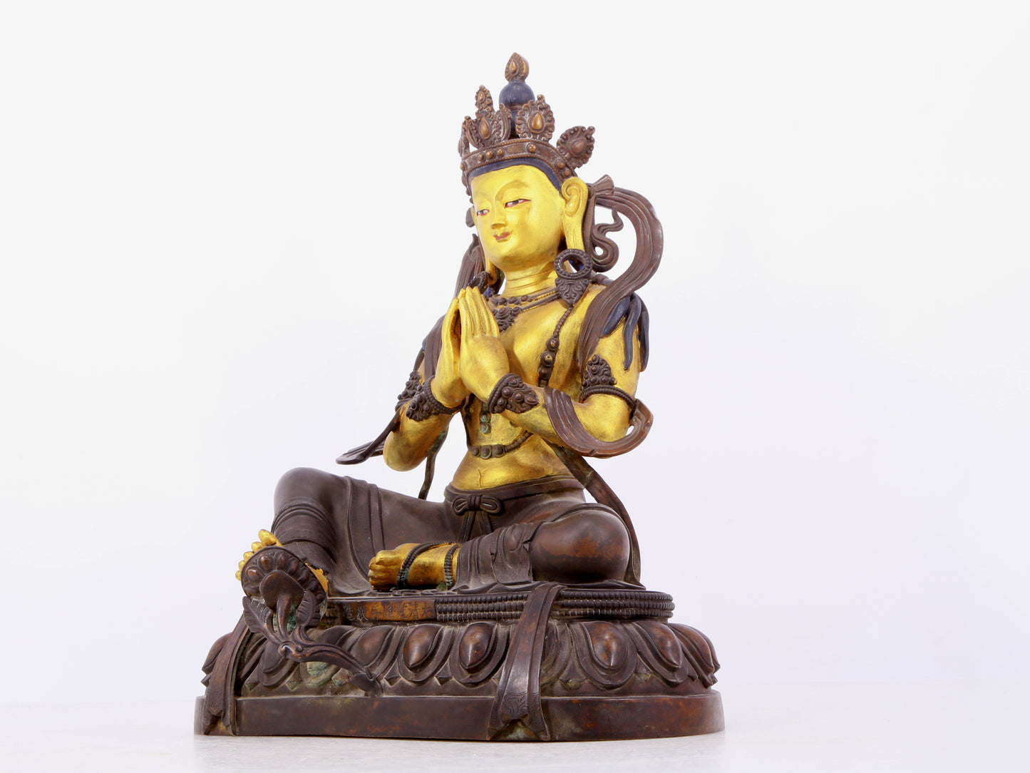 A solemn gilt bronze statue of green Tara