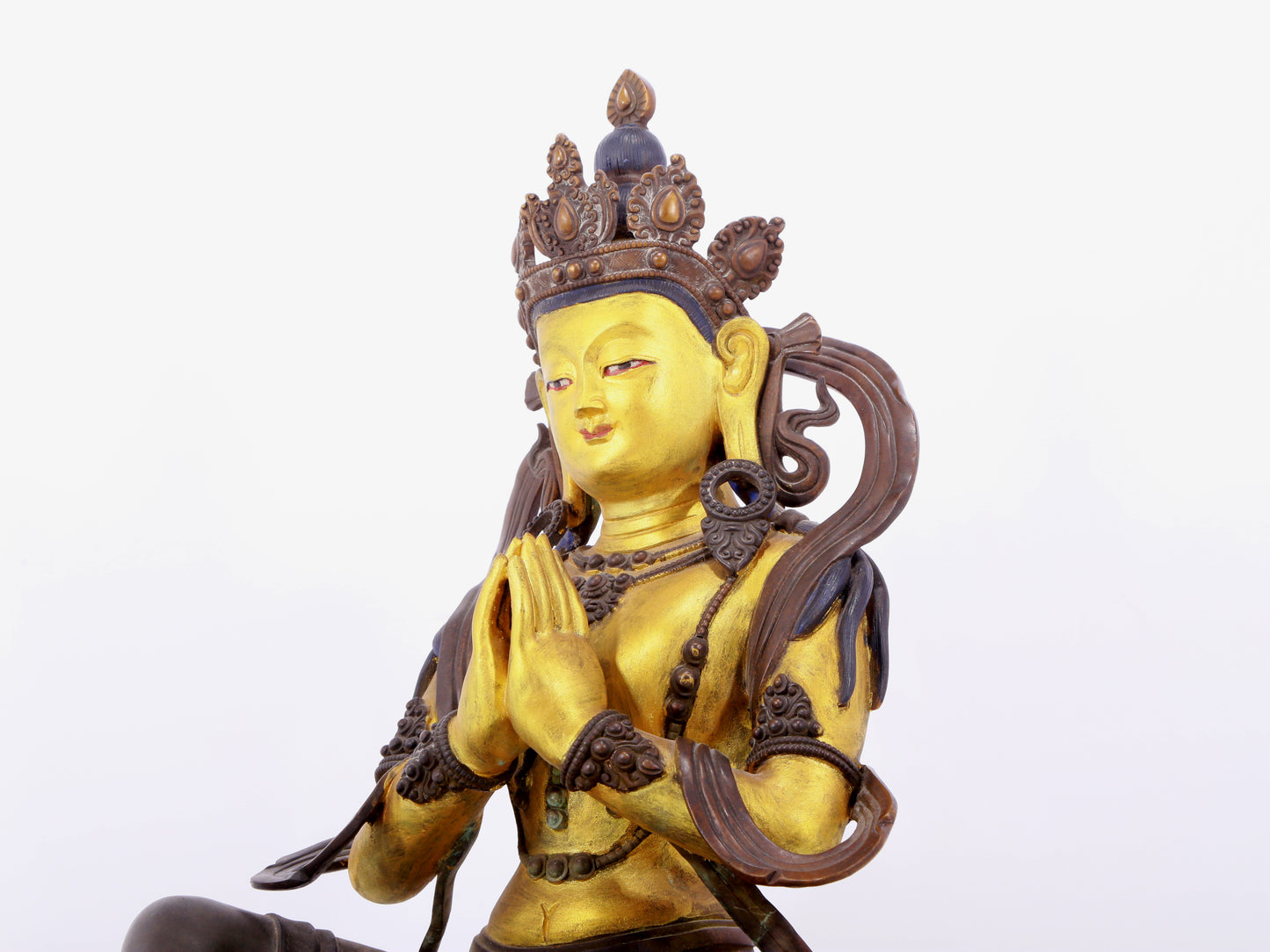 A solemn gilt bronze statue of green Tara