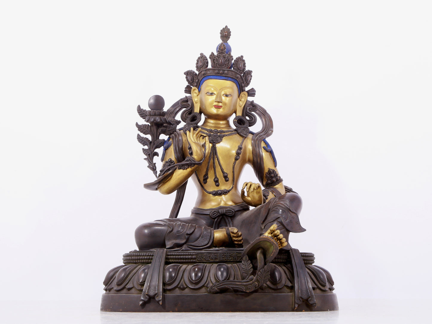 A solemn gilt bronze statue of green Tara