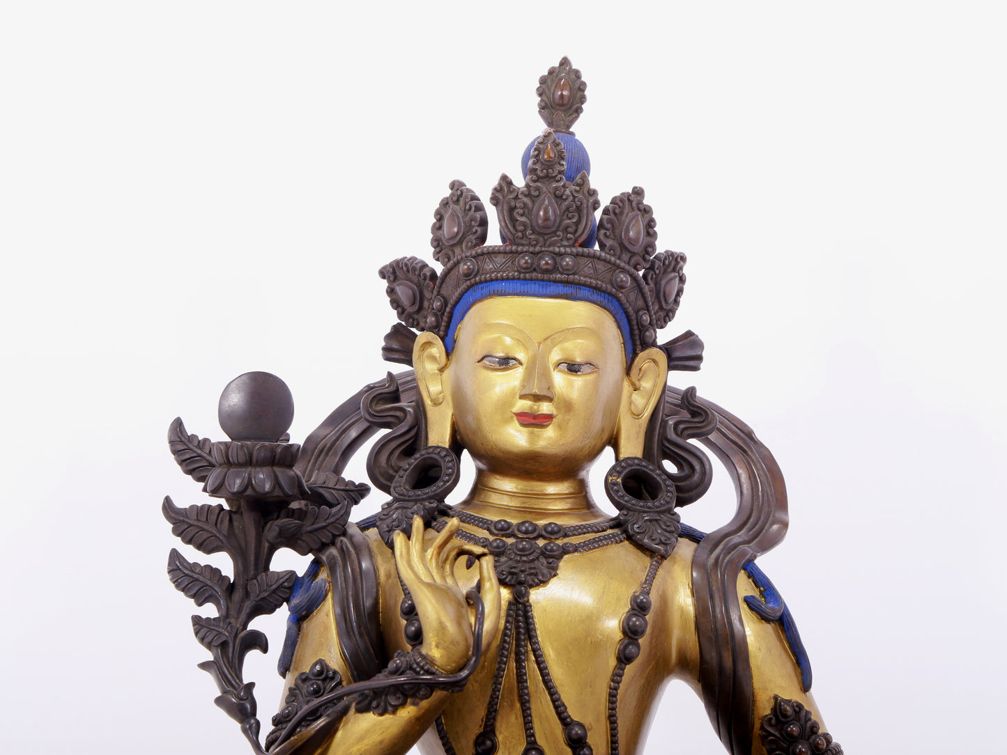 A solemn gilt bronze statue of green Tara