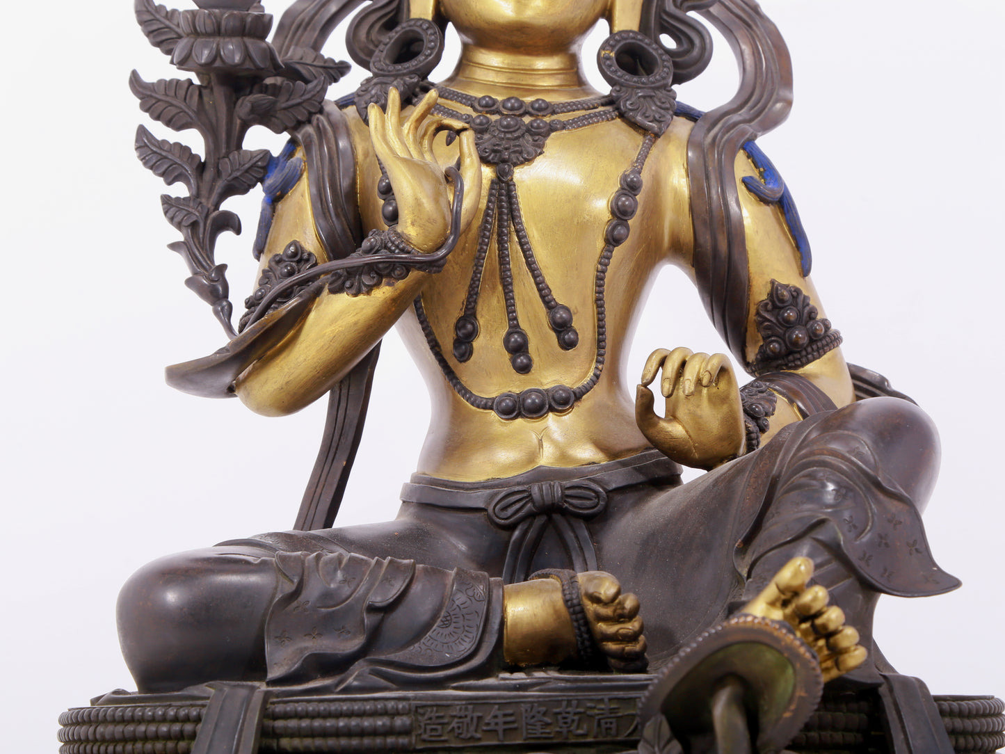 A solemn gilt bronze statue of green Tara