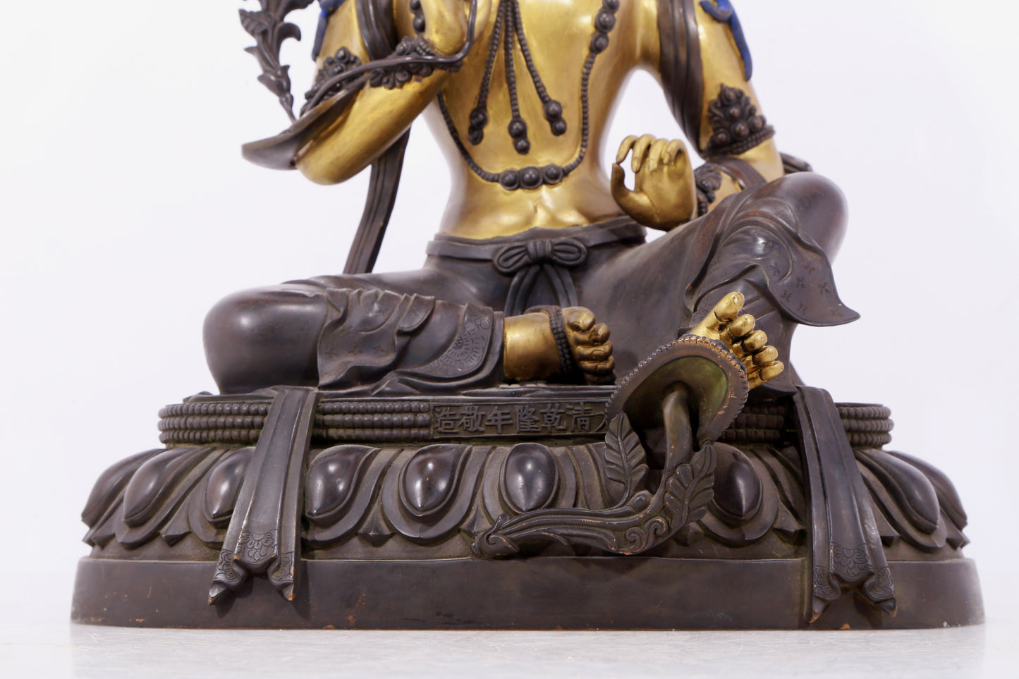 A solemn gilt bronze statue of green Tara