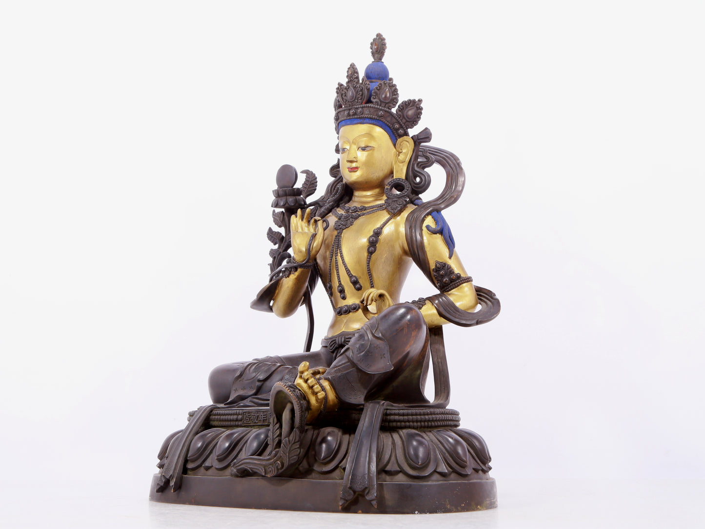 A solemn gilt bronze statue of green Tara