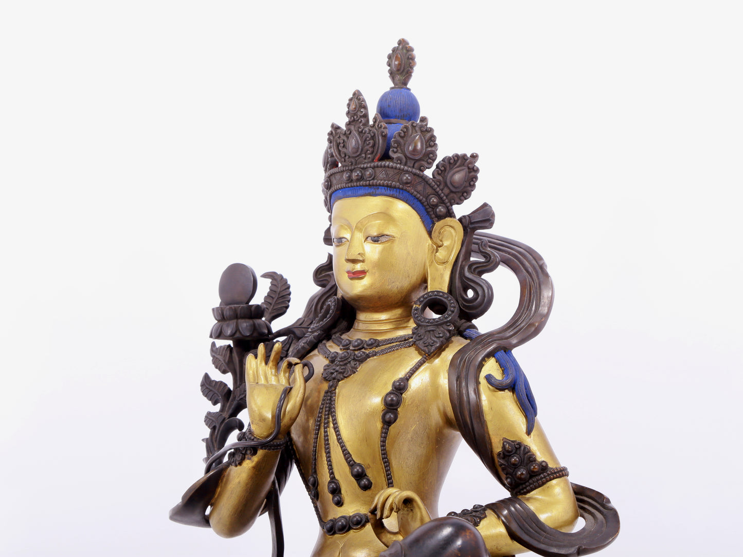 A solemn gilt bronze statue of green Tara