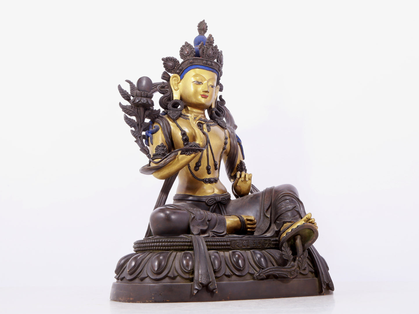 A solemn gilt bronze statue of green Tara