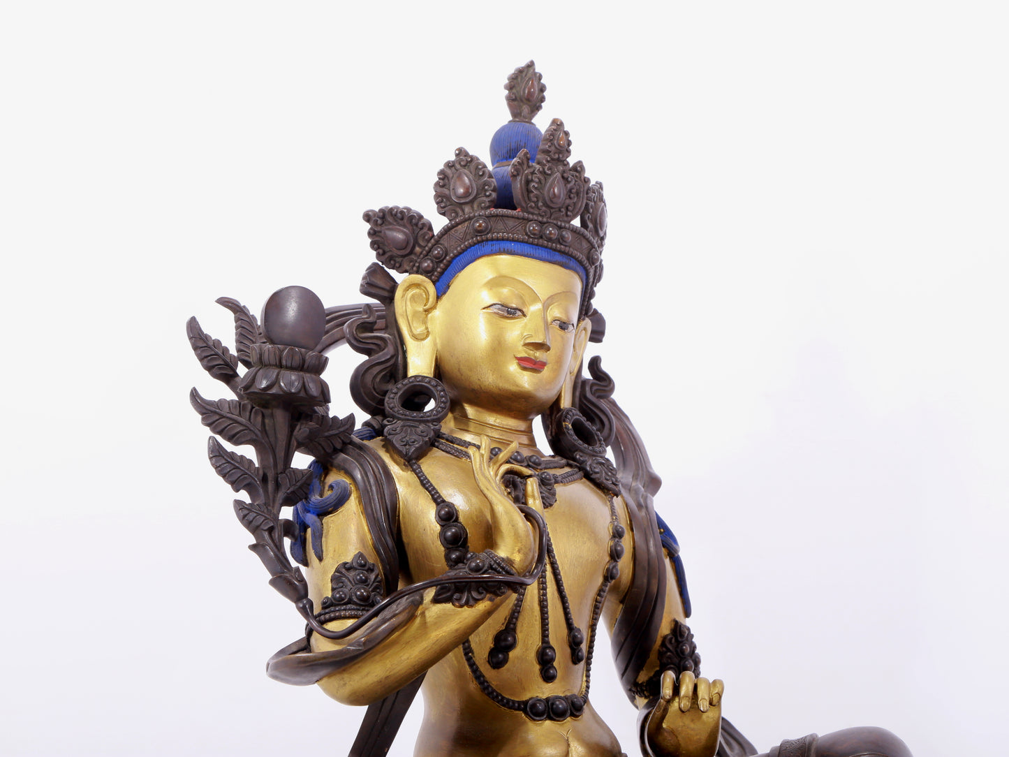 A solemn gilt bronze statue of green Tara