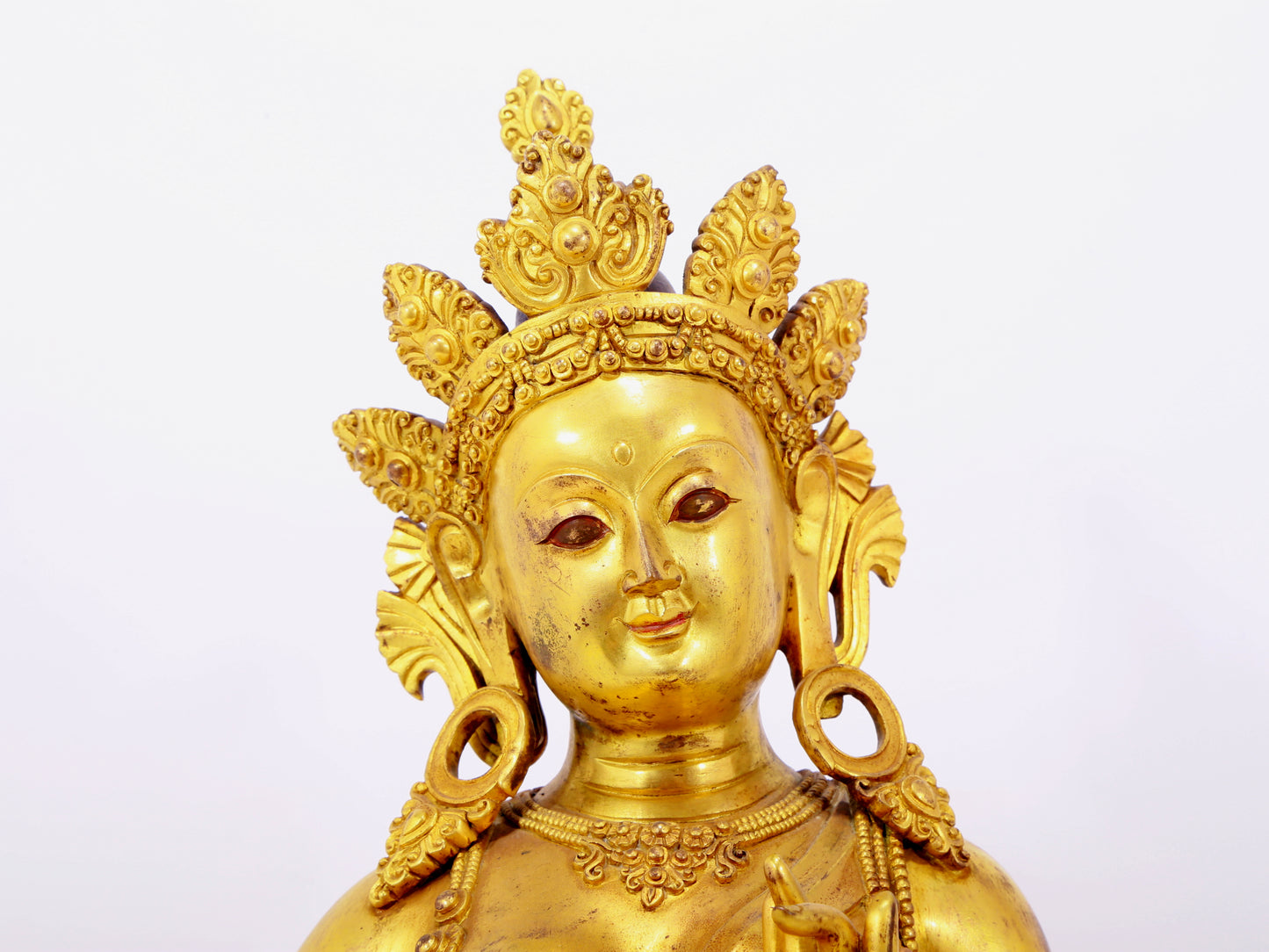 A solemn gilt bronze statue of green Tara