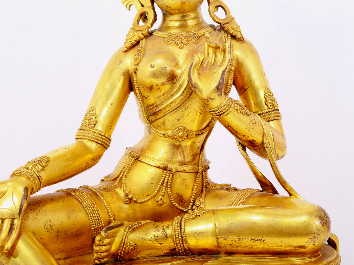 A solemn gilt bronze statue of green Tara