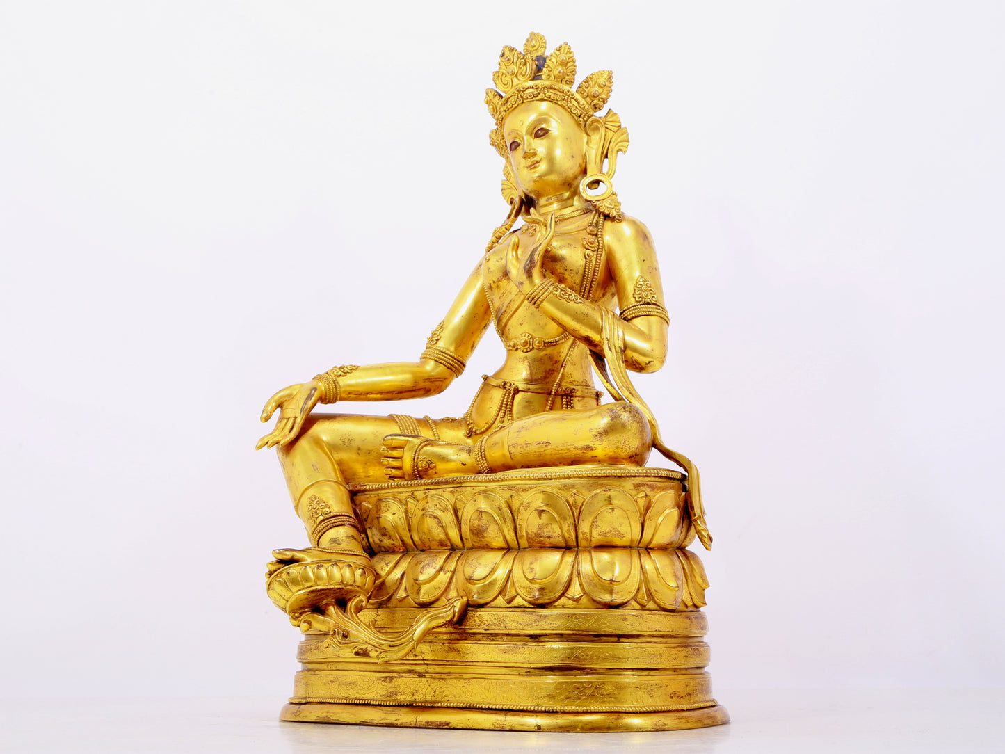 A solemn gilt bronze statue of green Tara