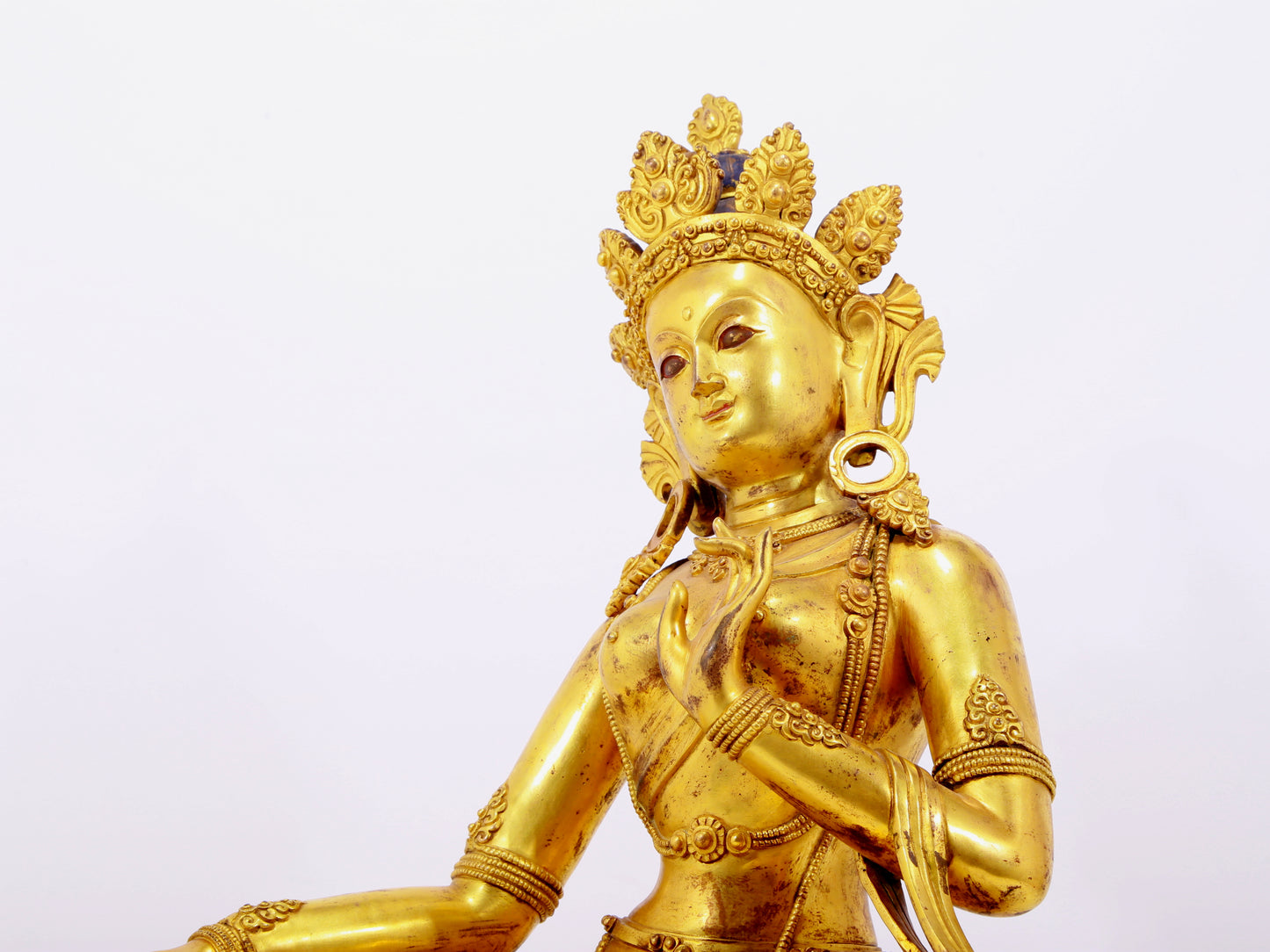 A solemn gilt bronze statue of green Tara