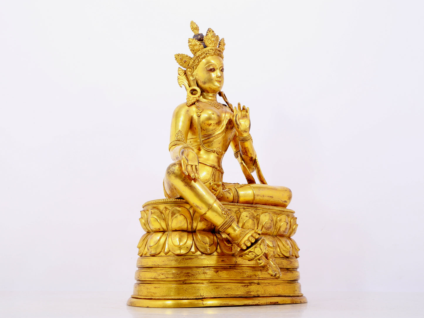 A solemn gilt bronze statue of green Tara