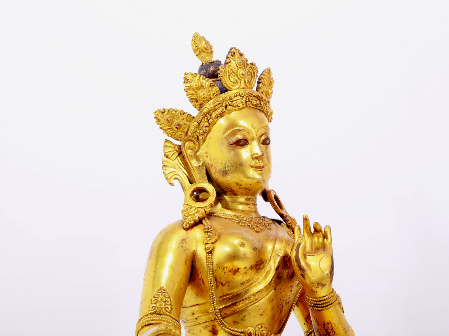 A solemn gilt bronze statue of green Tara