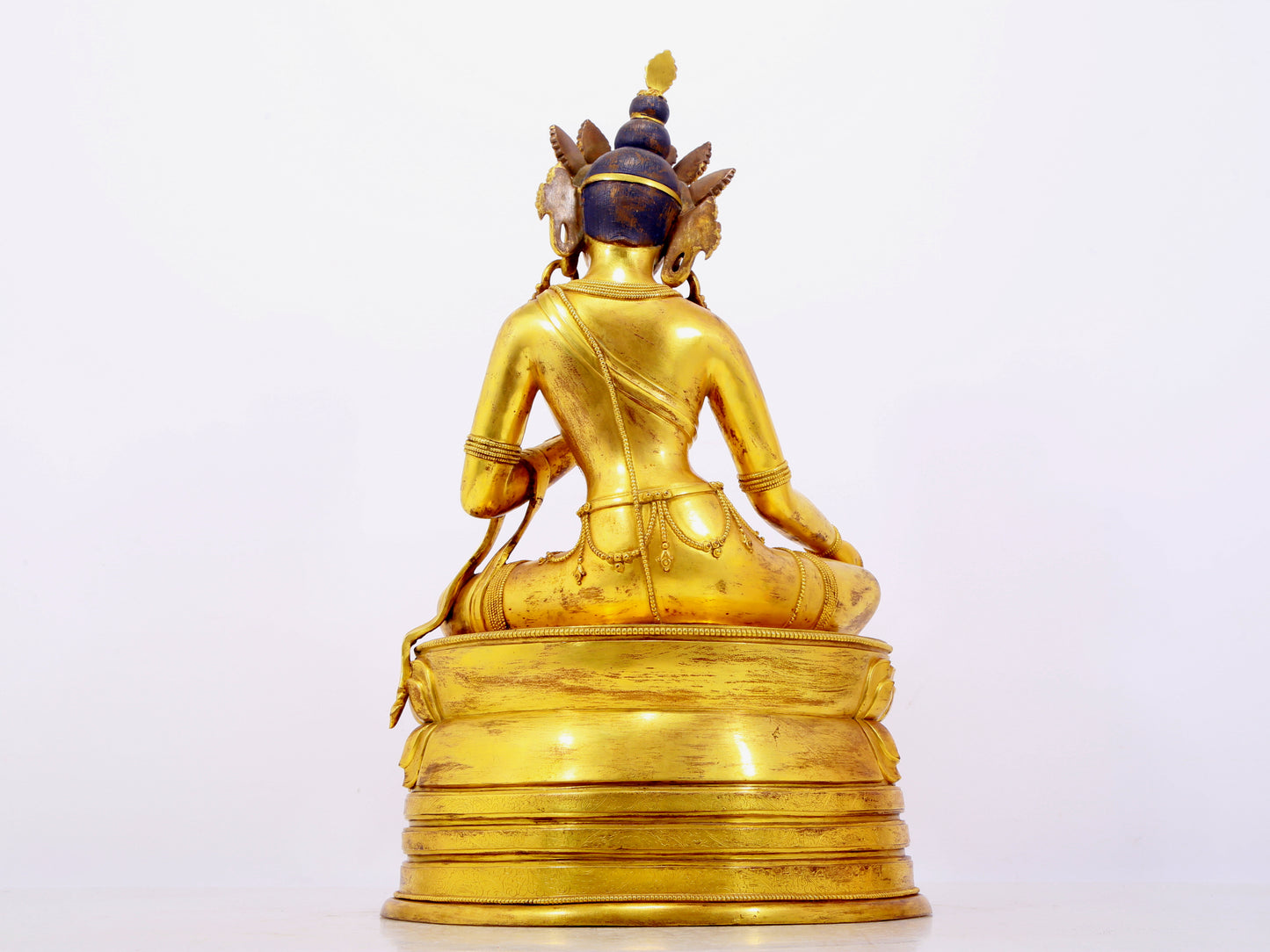 A solemn gilt bronze statue of green Tara