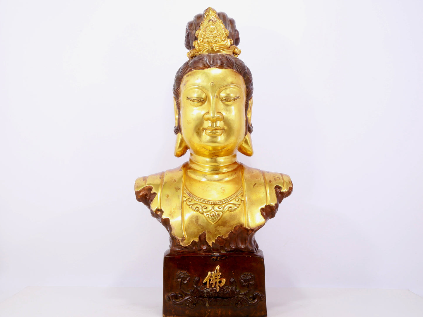 A solemn gilt bronze statue of Guanyin