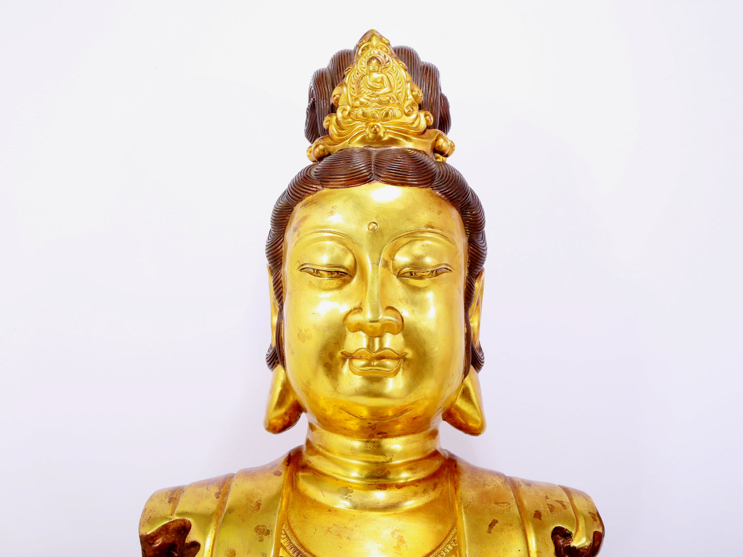 A solemn gilt bronze statue of Guanyin