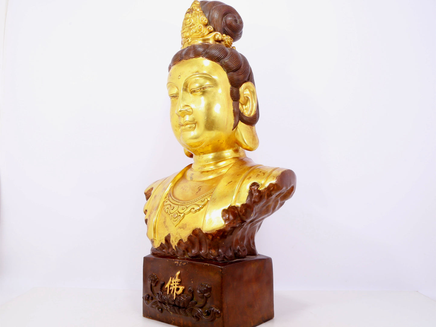 A solemn gilt bronze statue of Guanyin