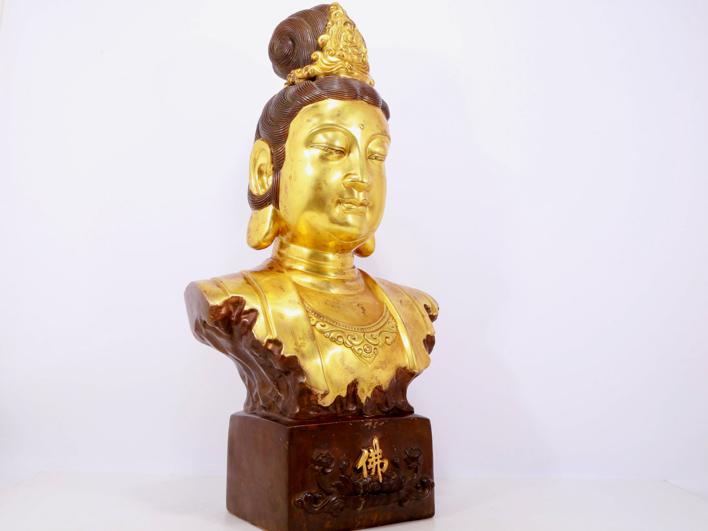 A solemn gilt bronze statue of Guanyin